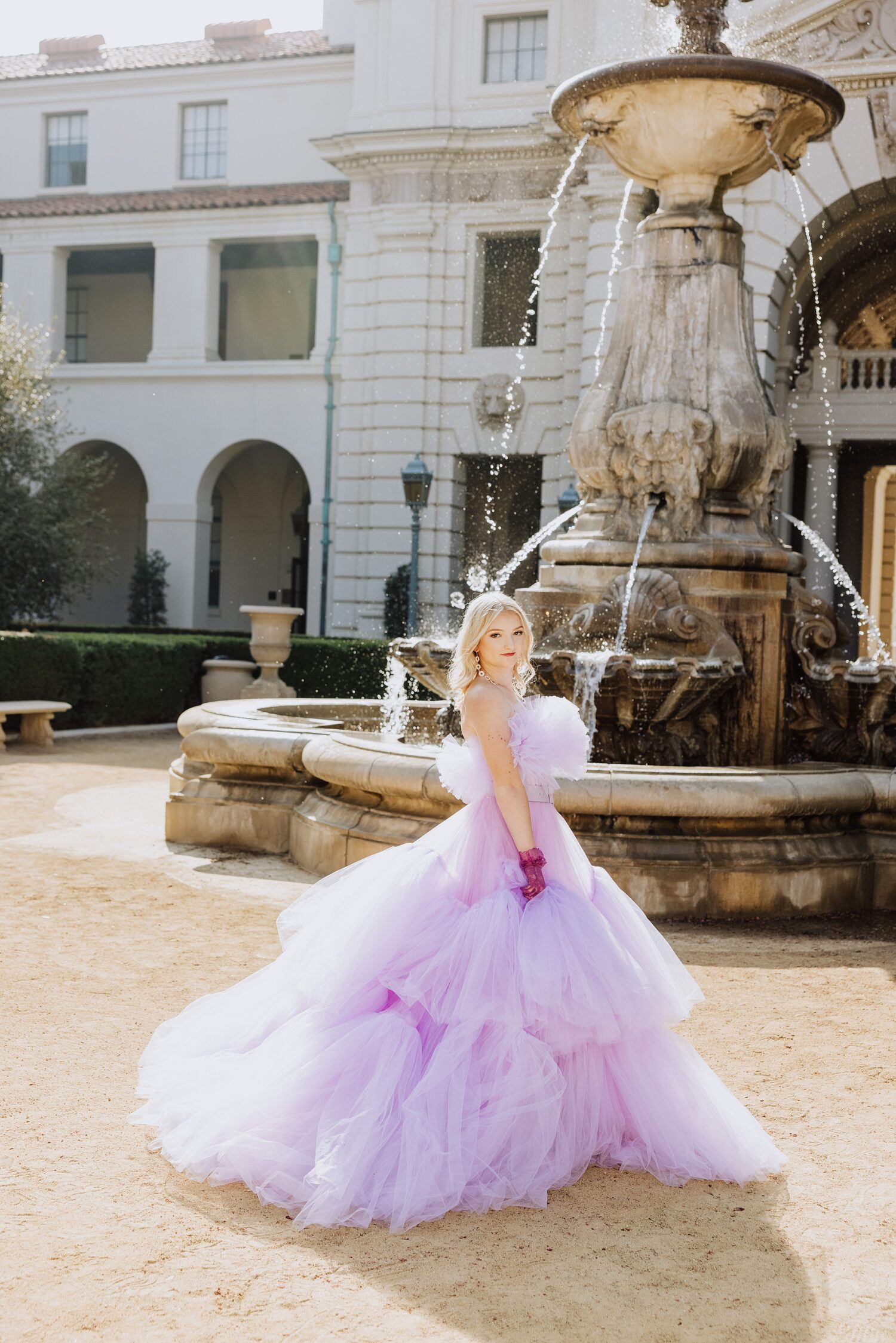 Pasadena senior pictures featuring an editorial gown and dramatic fountain backdrop in Southern California