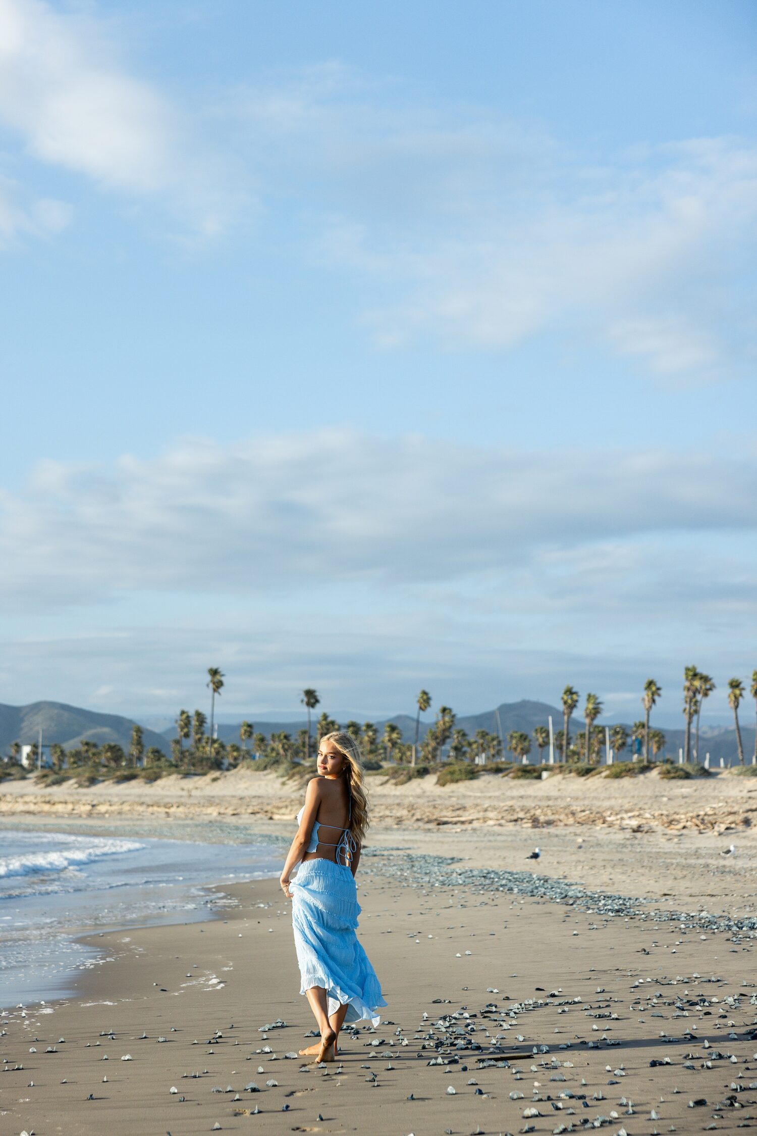 senior portraits Ventura beach California blue sky palm trees golden hour
